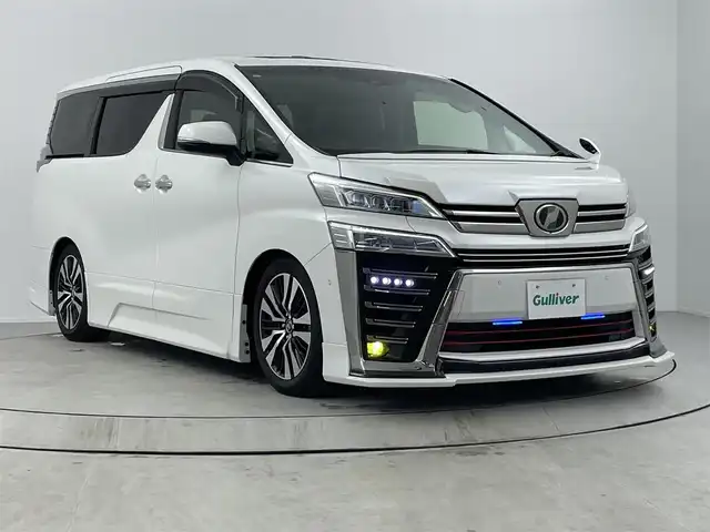 トヨタ ヴェルファイア Z Gエディション 熊本県 2018(平30)年 8万km ホワイトパールクリスタルシャイン ＪＢＬプレミアムサウンド　/駐車支援システム　/メーカー純正ナビ/CD/DVD/ Bluetooth/SD/AM/FM/フリップダウンモニター/バックカメラ/前方ドライブレコーダー　/サンルーフ　/1.2列目パワーシート/前席シートヒーターシートクーラー/オットマン/革巻きステアリング/ステアリングヒーター/ステアリングリモコン/革シート/エアシート　/シートヒーター　/クルーズコントロール　/社外エアロ　/社外サス/純正AW/純正フロアマット/純正ドアバイザー/スマートキー/スペアキー×１
