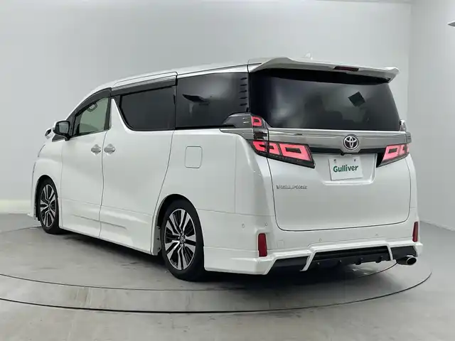 トヨタ ヴェルファイア Z Gエディション 熊本県 2018(平30)年 8万km ホワイトパールクリスタルシャイン ＪＢＬプレミアムサウンド　/駐車支援システム　/メーカー純正ナビ/CD/DVD/ Bluetooth/SD/AM/FM/フリップダウンモニター/バックカメラ/前方ドライブレコーダー　/サンルーフ　/1.2列目パワーシート/前席シートヒーターシートクーラー/オットマン/革巻きステアリング/ステアリングヒーター/ステアリングリモコン/革シート/エアシート　/シートヒーター　/クルーズコントロール　/社外エアロ　/社外サス/純正AW/純正フロアマット/純正ドアバイザー/スマートキー/スペアキー×１