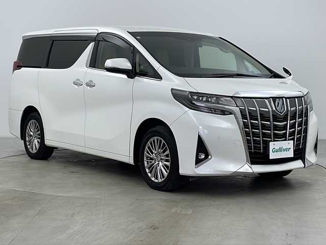 トヨタ アルファードハイブリット G Fパッケージ 道央・札幌 2021(令3)年 5.1万km ホワイトパールクリスタルシャイン ４WD/9インチメモリナビ/（DVD/TV/BT）/フリップダウンモニター/衝突軽減/レーンキープアシスト/操舵支援/追従機能付きクルーズコントロール/クリアランスソナー/パーキングサポートブレーキ/先行車発進検知/電動パーキングブレーキ/バックカメラ/ドライブレコーダー/ビルドインETC（２．０）/AC100V電源/自動防眩ミラー/オートハイビーム/両側パワースライドドア/パワーバックドア/ステアリングスイッチ/ステアリングヒーター/MTモード付AT/ベージュレザーシート/運転席シートメモリー/前席シートヒーター/前席エアシート/１，２列目電動シート/サンシェード/3眼LED/フォグランプ/シーケンシャルウィンカー/ウィンカーミラー/電格ミラー