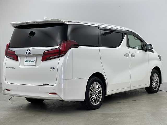 トヨタ アルファードハイブリット G Fパッケージ 道央・札幌 2021(令3)年 5.1万km ホワイトパールクリスタルシャイン ４WD/9インチメモリナビ/（DVD/TV/BT）/フリップダウンモニター/衝突軽減/レーンキープアシスト/操舵支援/追従機能付きクルーズコントロール/クリアランスソナー/パーキングサポートブレーキ/先行車発進検知/電動パーキングブレーキ/バックカメラ/ドライブレコーダー/ビルドインETC（２．０）/AC100V電源/自動防眩ミラー/オートハイビーム/両側パワースライドドア/パワーバックドア/ステアリングスイッチ/ステアリングヒーター/MTモード付AT/ベージュレザーシート/運転席シートメモリー/前席シートヒーター/前席エアシート/１，２列目電動シート/サンシェード/3眼LED/フォグランプ/シーケンシャルウィンカー/ウィンカーミラー/電格ミラー