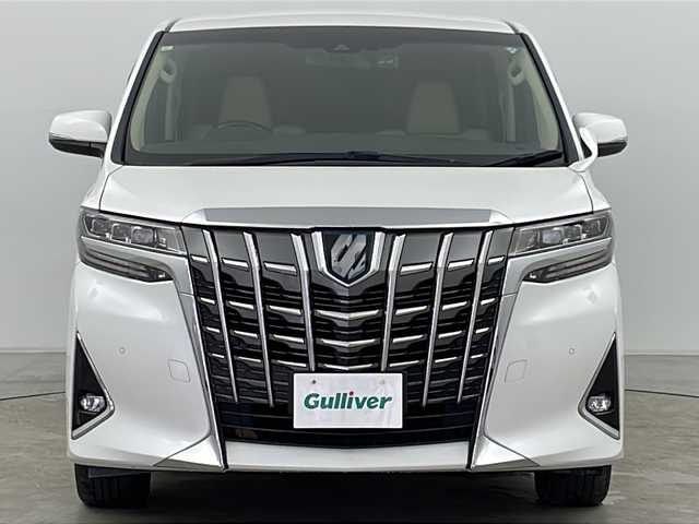 トヨタ アルファードハイブリット G Fパッケージ 道央・札幌 2021(令3)年 5.1万km ホワイトパールクリスタルシャイン ４WD/9インチメモリナビ/（DVD/TV/BT）/フリップダウンモニター/衝突軽減/レーンキープアシスト/操舵支援/追従機能付きクルーズコントロール/クリアランスソナー/パーキングサポートブレーキ/先行車発進検知/電動パーキングブレーキ/バックカメラ/ドライブレコーダー/ビルドインETC（２．０）/AC100V電源/自動防眩ミラー/オートハイビーム/両側パワースライドドア/パワーバックドア/ステアリングスイッチ/ステアリングヒーター/MTモード付AT/ベージュレザーシート/運転席シートメモリー/前席シートヒーター/前席エアシート/１，２列目電動シート/サンシェード/3眼LED/フォグランプ/シーケンシャルウィンカー/ウィンカーミラー/電格ミラー