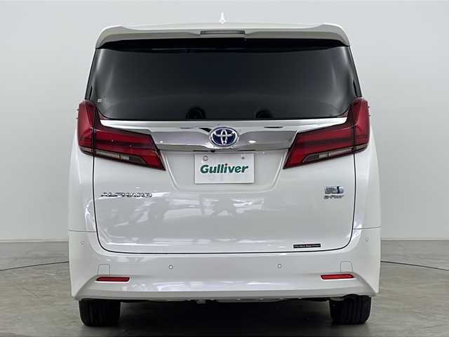 トヨタ アルファードハイブリット G Fパッケージ 道央・札幌 2021(令3)年 5.1万km ホワイトパールクリスタルシャイン ４WD/9インチメモリナビ/（DVD/TV/BT）/フリップダウンモニター/衝突軽減/レーンキープアシスト/操舵支援/追従機能付きクルーズコントロール/クリアランスソナー/パーキングサポートブレーキ/先行車発進検知/電動パーキングブレーキ/バックカメラ/ドライブレコーダー/ビルドインETC（２．０）/AC100V電源/自動防眩ミラー/オートハイビーム/両側パワースライドドア/パワーバックドア/ステアリングスイッチ/ステアリングヒーター/MTモード付AT/ベージュレザーシート/運転席シートメモリー/前席シートヒーター/前席エアシート/１，２列目電動シート/サンシェード/3眼LED/フォグランプ/シーケンシャルウィンカー/ウィンカーミラー/電格ミラー