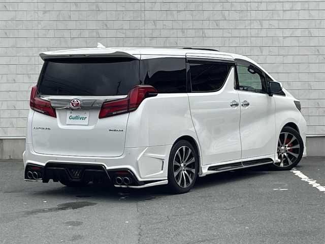 トヨタ アルファード S タイプゴールド 愛知県 2020(令2)年 6.7万km ホワイトパールクリスタルシャイン ・ROJAM IRT GENIK フルエアロ/・ROJAMマフラー/・ROJAMキャリパーカバー/・TEIN車高調/・純正JBLサウンド付ディスプレイオーディオ（ナビ有り）/・フルセグTV/・CD/DVD再生/・ミュージックサーバー（SD録音）/・Bluetooth/USB接続/・全方位カメラ/・ETC2.0/・電動開閉フリップダウンモニター/・両側パワースライドドア/・社外製19インチアルミホイール/・サンルーフ/・純正フロアマット/・オットマン/・電動リアゲート/・LEDヘッドライト/・オートマチックハイビーム/・コーナーセンサー/・横滑り防止装置/・衝突軽減ブレーキ/・レーンキープアシスト/・電動パーキングブレーキ/・ブレーキホールド/・デジタルインナーミラー/・ドライブレコーダー（デジタルインナーミラー内蔵型）/・アダプティブクルーズコントロール/・ルーフカラーイルミネーション
