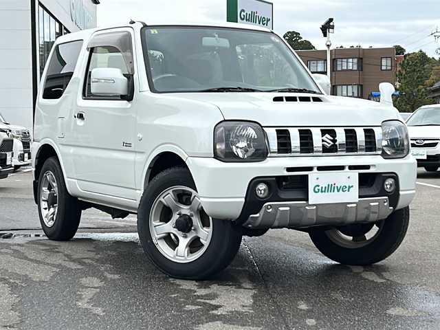 スズキ ジムニー クロスアドベンチャー 石川県 2014(平26)年 5.1万km パールホワイト 4WD/社外メモリナビゲーション/【CD・Bluetooth・AUX】/型番：GCX513/運転席シートヒーター/電動格納ミラー/・ウインカーミラー/・ヒーテッドドアミラー/フォグランプ/サロモンシート/背面タイヤ/ヘッドライトレベライザー/フロアマット/ドアバイザー