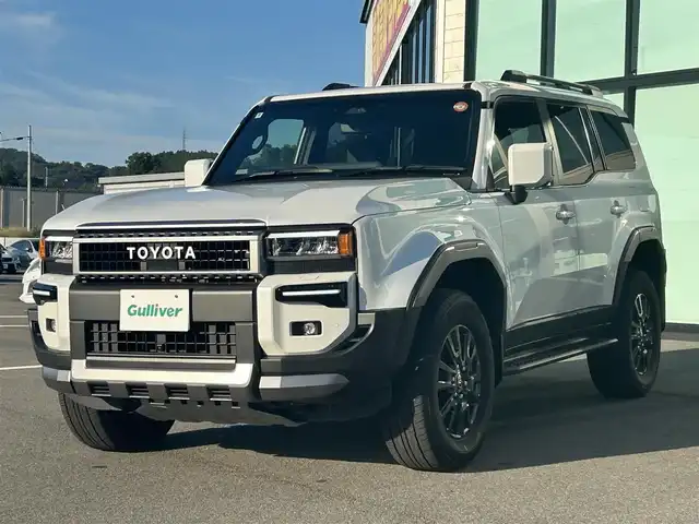 トヨタ ランドクルーザー ２５０ VX 愛媛県 2024(令6)年 1.9万km プラチナホワイトパールマイカ 純正ナビ（Bluetooth/フルセグTV）/ワンオーナー/パノラミックビューモニター/ETC2.0/レーダークルーズコントロール/サンルーフ/レザーシート/パワーシート/シートヒーター/シートベンチレーション/ステアリングリモコン/モデリスタ製フロント＆リアバンパーガーニッシュ/シグネチャーイルミブレード/AppleCarPlay/スペアタイヤ/パワーバックドア/前後コーナーセンサー/純正アルミホイール