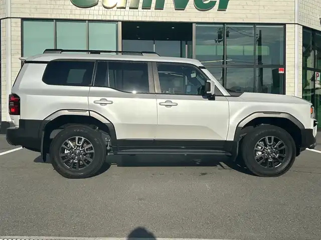 トヨタ ランドクルーザー ２５０ VX 愛媛県 2024(令6)年 1.9万km プラチナホワイトパールマイカ 純正ナビ（Bluetooth/フルセグTV）/ワンオーナー/パノラミックビューモニター/ETC2.0/レーダークルーズコントロール/サンルーフ/レザーシート/パワーシート/シートヒーター/シートベンチレーション/ステアリングリモコン/モデリスタ製フロント＆リアバンパーガーニッシュ/シグネチャーイルミブレード/AppleCarPlay/スペアタイヤ/パワーバックドア/前後コーナーセンサー/純正アルミホイール