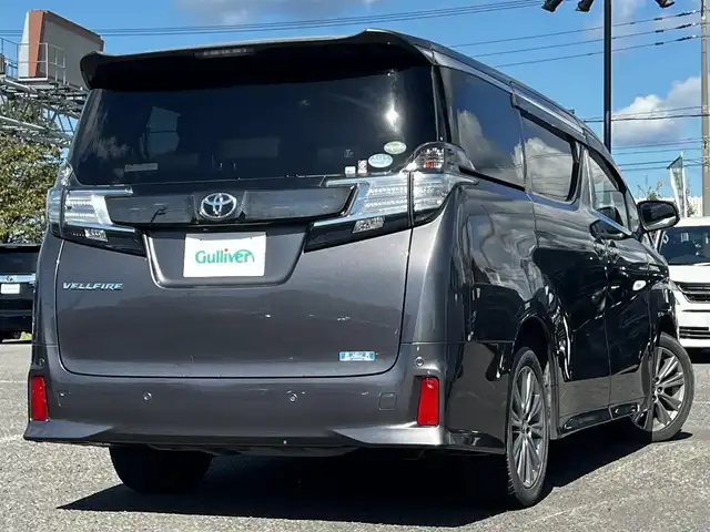 トヨタ ヴェルファイア 3.5ZA ゴールデンアイズ 道央・札幌 2016(平28)年 7.7万km グレーメタリック ４WD/純正SDナビ/AM/FM/BT/CD/DVD/フルセグ/純正フリップダウンモニター/衝突被害軽減ブレーキ/横滑り防止装置/レーダークルーズコントロール/クリアランスソナー/バックカメラ/ビルトインETC/ECOMODE/両側パワースライドドア/パワーバックドア/オットマン/ハーフレザーシート/革巻きウッドコンビステアリング/ステアリングリモコン/AC100V/電動パーキング/ブレーキホールド/MTモード付AT/プッシュスタート/スマートキー/LEDヘッドライト/オートライト/フォグランプ/電動格納ミラー/ウィンカーミラー/純正フロアマット/ドアバイザー