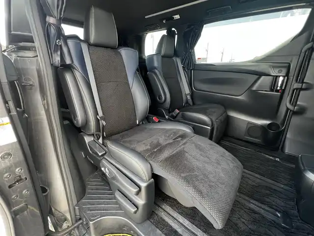 トヨタ ヴェルファイア 3.5ZA ゴールデンアイズ 道央・札幌 2016(平28)年 7.7万km グレーメタリック ４WD/純正SDナビ/AM/FM/BT/CD/DVD/フルセグ/純正フリップダウンモニター/衝突被害軽減ブレーキ/横滑り防止装置/レーダークルーズコントロール/クリアランスソナー/バックカメラ/ビルトインETC/ECOMODE/両側パワースライドドア/パワーバックドア/オットマン/ハーフレザーシート/革巻きウッドコンビステアリング/ステアリングリモコン/AC100V/電動パーキング/ブレーキホールド/MTモード付AT/プッシュスタート/スマートキー/LEDヘッドライト/オートライト/フォグランプ/電動格納ミラー/ウィンカーミラー/純正フロアマット/ドアバイザー