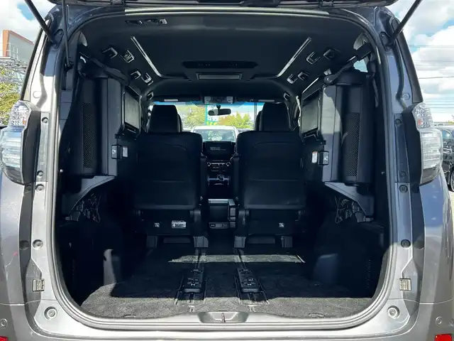 トヨタ ヴェルファイア 3.5ZA ゴールデンアイズ 道央・札幌 2016(平28)年 7.7万km グレーメタリック ４WD/純正SDナビ/AM/FM/BT/CD/DVD/フルセグ/純正フリップダウンモニター/衝突被害軽減ブレーキ/横滑り防止装置/レーダークルーズコントロール/クリアランスソナー/バックカメラ/ビルトインETC/ECOMODE/両側パワースライドドア/パワーバックドア/オットマン/ハーフレザーシート/革巻きウッドコンビステアリング/ステアリングリモコン/AC100V/電動パーキング/ブレーキホールド/MTモード付AT/プッシュスタート/スマートキー/LEDヘッドライト/オートライト/フォグランプ/電動格納ミラー/ウィンカーミラー/純正フロアマット/ドアバイザー