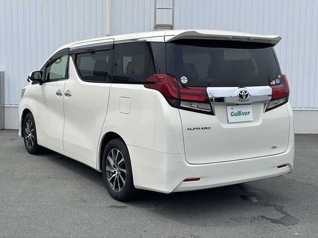 トヨタ アルファード G 三重県 2015(平27)年 5.7万km ラグジュアリーホワイトパールクリスタルシャインガラスフレーク プッシュスタート/電動格納ミラー/両側パワースライドドア/ビルトインETC/横滑り防止/レーダークルーズコントロール/パワーシート{D+N席）/オットマン/ステアリングスイッチ/革巻きステアリング/オートライト/前後ドライブレコーダー/後席フリップダウンモニター/電動パーキング/純正フロアマット/純正9型ナビ（AM/FM/CD/DVD/TV/BT）/フルセグTV/コーナーセンサー/パワーバックドア/スペアキー/リアサンシェード/LEDヘッドライト