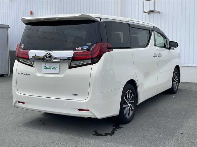 トヨタ アルファード G 三重県 2015(平27)年 5.7万km ラグジュアリーホワイトパールクリスタルシャインガラスフレーク プッシュスタート/電動格納ミラー/両側パワースライドドア/ビルトインETC/横滑り防止/レーダークルーズコントロール/パワーシート{D+N席）/オットマン/ステアリングスイッチ/革巻きステアリング/オートライト/前後ドライブレコーダー/後席フリップダウンモニター/電動パーキング/純正フロアマット/純正9型ナビ（AM/FM/CD/DVD/TV/BT）/フルセグTV/コーナーセンサー/パワーバックドア/スペアキー/リアサンシェード/LEDヘッドライト