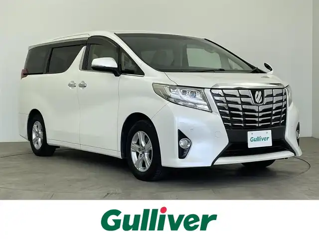 トヨタ アルファード X 大分県 2015(平27)年 7.7万km ホワイトパールクリスタルシャイン 純正SDナビ/(フルセグ/CD/DVD/BT)/片側パワースライドドア/バックカメラ/ビルトインETC/前方ドライブレコーダー/オートライト/電動パーキングブレーキ/ステアリングスイッチ/アイドリングストップ/スマートキー/プッシュスタート/スペアキー/MTモード付きAT