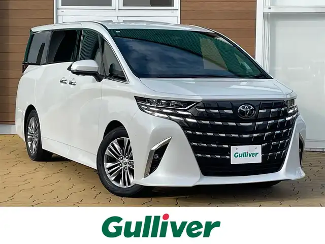 トヨタ アルファードハイブリット Z 宮崎県 2023(令5)年 2.3万km プラチナホワイトパールマイカ 左右独立ムーンルーフ/13.2インチフリップダウンモニター/セーフティセンス/・プリクラッシュセーフティ/・レーントレーシングアシスト/・レーンディパーチャーアラート/・全車速追従機能付レーダークルーズコントロール/・アダクティブハイビームシステム/・ロードサインアシスト/・ドライバー異常時対応システム/・プロアクティブドライビングアシスト/・発進遅れ告知機能/BSM（ブラインドスポットモニター）/14インチディスプレイオーディオ/ナビ／BT/USB/HDMI/フルセグTV／AppleCarPlay／Andorid audio/ETC2.0/パノラミックビューモニター/デジタルインナーミラー/おくだけ充電/パワーシート（運転席メモリー機能付）前席／2列目/パワーサンシェード　2列目／3列目/パワーバックドア/プッシュスタート／スマートキー/社外フロアマット