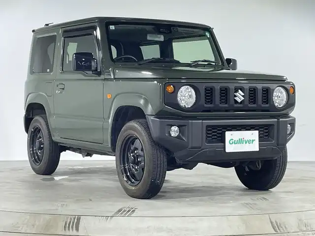スズキ ジムニー XL 福岡県 2019(令1)年 1.8万km ジャングルグリーン ・ワンオーナー/・５速ＭＴ　/・社外オーディオ　/（ＡＭ　ＦＭ　ＵＳＢ　ＣＤ）　/・ダウンヒルアシスト　/・衝突軽減システム　/・レーンキープ　/・横滑り防止　/・シートヒーター　/・背面タイヤ　/・オートライト　/・ハロゲンヘッドライト　/・電格ミラー/・スペアキー