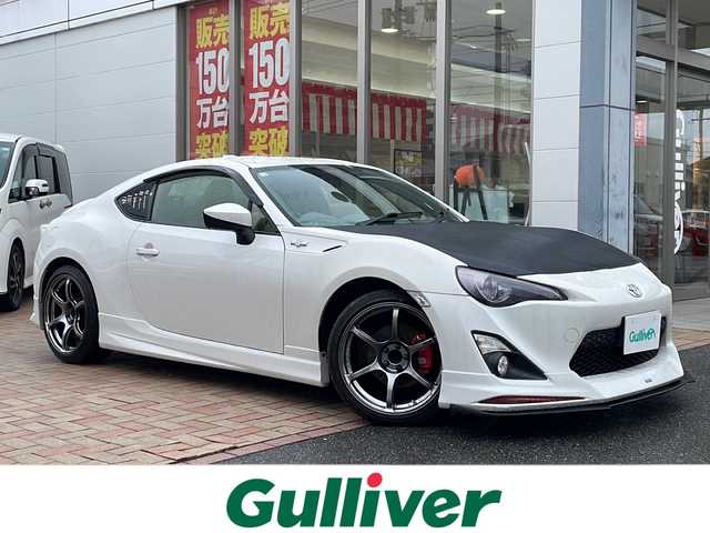 トヨタ ８６ GT 鳥取県 2012(平24)年 7.9万km サテンホワイトパール モデリスタエアロ/アドバン18インチAW/柿本改マフラー/社外ディスプレイオーディオ/社外ヘッドライト/社外テールライト（純正あり）/社外リップスポイラー/社外ステアリング/社外インテリアパネル/アペックス車高調（積込）/ボンネットラッピング