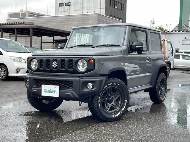 スズキ ジムニー シエラ JC 福井県 2023(令5)年 1万km ミディアムグレー 4WD/社外ディスプレイオーディオ/（Apple CarPlay）/プリクラッシュセーフティ/レーンキープアシスト/クルーズコントロール/純正16インチアルミホイール/背面タイヤ/LEDヘッドライト/フォグランプ/シートヒーター /アイドリングストップ/電動格納ミラー/オートライト/プッシュスタート/スマートキー/保証書/取扱説明書