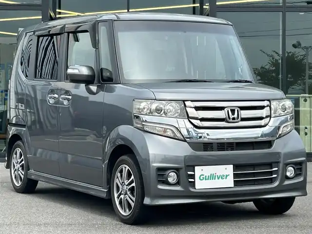 ホンダ Ｎ ＢＯＸ カスタム G Lパッケージ 愛媛県 2015(平27)年 6.1万km ポリッシュドメタルメタリック 純正7型ナビ(AM/FM/CD/DVD/BTワンセグTV)/左側電動スライド/ドライブレコーダー/バックカメラ/純正フロアマット/ステアリングリモコン/電格ミラー/純正ドアバイザー/シガーソケット/ISOFIX/フォグランプ/オートライト/ETC/現状サマー(純正AW)(155/65/R14)/TOYO SD-K7
