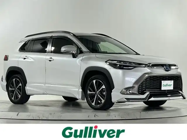 トヨタ カローラ クロス ハイブリッド Z 熊本県 2022(令4)年 1.8万km プラチナホワイトパールマイカ 純正9インチナビ/フルセグTV/Bluetooth/モデリスタエアロ/トヨタセーフティセンス/プリクラッシュセーフティ/レーントレーシングアシスト/ブラインドスポットモニター/クリアランスソナー/パーキングサポートブレーキ/リアクロストラフィックアラート/ロードサインアシスト/全周囲カメラ/オートマチックハイビーム/パワーバックドア/レーダークルーズコントロール/ビルトインETC/ハーフレザーシート/前席シートヒーター/運転席パワーシート/USB入慮/LEDヘッドランプ/ルーフレール/純正18インチアルミホイール/ドアバイザー/フロアマット/スマートキー
