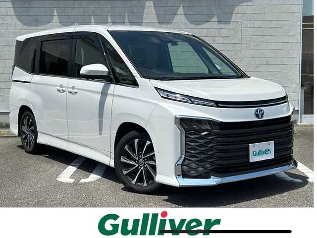 トヨタ ヴォクシー ハイブリッド S－Z 宮崎県 2022(令4)年 7万km ホワイトパールクリスタルシャイン 純正10.5インチナビ/フルセグTV/HDMI入力/純正14インチフリップダウンモニター/パノラマビューモニター/DVDキッド/ETC2.0/ヘッドアップディスプレイ/デジタルインナーミラー/レーダークルーズコントロール/レーンキープアシスト/パーキングアシストコントロール/ハンズフリーデュアルパワースライドドア/パワーバックドア/ステアリングヒーター/キャプテンシート/2列目オットマン/ステアリングリモコン/ドライブレコーダー/オービス対応レーダー/電動格納ミラー/USB充電