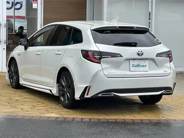 トヨタ カローラツーリング ハイブリッド ダブルバイビー 宮崎県 2019(令1)年 8.2万km ホワイトパールクリスタルシャイン 純正ディスプレイオーディオ＋ナビ/トヨタセーフティセンス/・クリアランスソナー/・プリクラッシュセーフティ/・ロードサインアシスト/・リヤクロストラフィックアラート/・レーンディパーチャーアラート/バックカメラ/ETC/モデリスタエアロ/ヘッドアップディスプレイ/レーダークルーズコントロール/シートヒーター/オートライト/オートハイビーム/LEDヘッドライト/スマートキー/プッシュスタート/電動格納ミラー/純正17インチAW/純正フロアマット