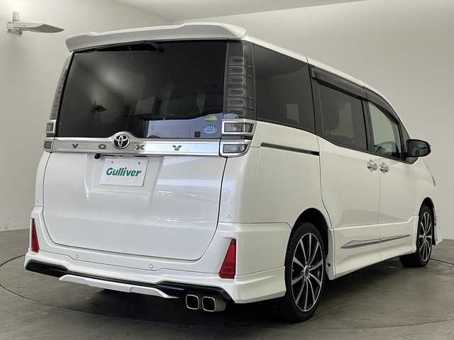 トヨタ ヴォクシー ZS 煌Ⅱ 兵庫県 2019(令1)年 5.6万km ホワイトパールクリスタルシャイン ・社外ナビ（AVIC-RZ810）/Bluetooth/CD/DVD/SD/TV/USB/・バックカメラ/・ETC/・モデリスタエアロ/・両側パワースライドドア/・トヨタセーフティセンス/・プリクラッシュセーフティ/・クルーズコントロール/・レーンキープアシスト/・アイドリングストップ/・オートライト/・オートマチックハイビーム/・LEDライト&LEDフォグ/・リアヒーター/・スマートキー/・スペアキー/・WACエアコン/・三列シート/・純正フロアマット/・社外アルミホイール/・Wエアバック/・ロールサンシェード/・シートバックテーブル/・クリアランスソナー/・革巻きステアリング