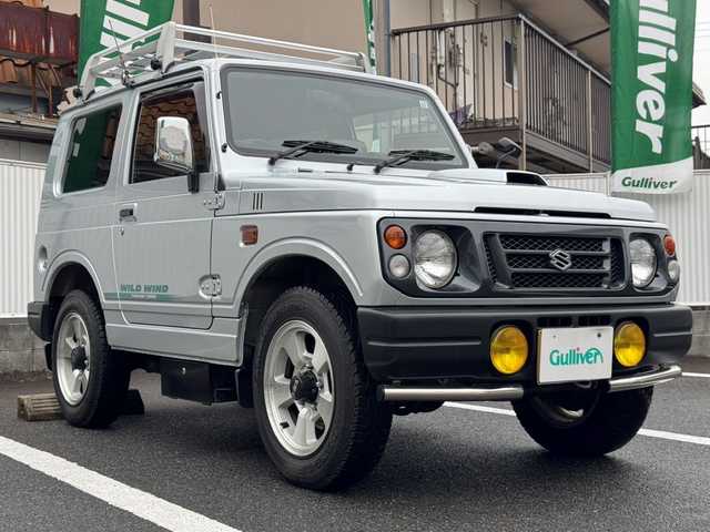 スズキ ジムニー ワイルドウィンド 岡山県 1995(平7)年 4万km マーキュリーシルバーメタリック 4WD/ルーフキャリア/スペアキー/背面タイヤ/背面タイヤハードカバー/フォグランプ/純正16インチアルミホイール/取扱説明書