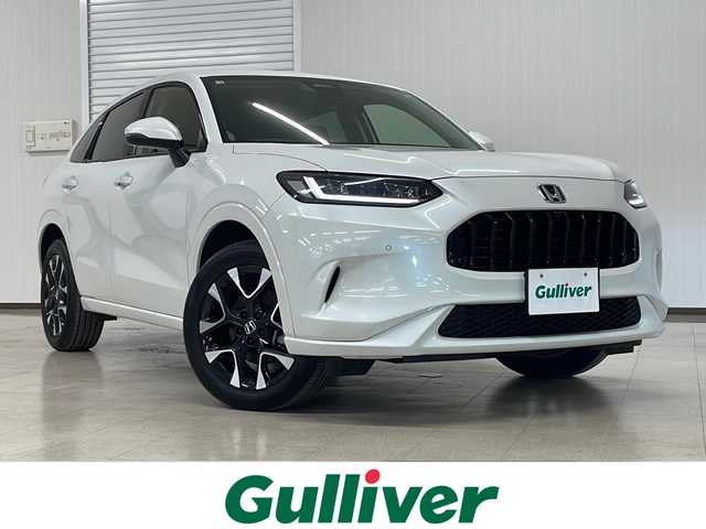 ホンダ ＺＲ－Ｖ ハイブリッド e:HEV Z 熊本県 2023(令5)年 2.6万km プラチナホワイトパール 純正ディスプレイオーディオ（ＢＴ/ラジオ/フルセグ）/全方位カメラ/前方ドライブレコーダー/ビルトインETC2.0/コーナーセンサー/パドルシフト/MTモード付AT/USB/ブレーキホールド/パワーシート/シートメモリー/シートヒーター/ステアリングヒーター/置くだけ充電/クルーズコントロール追従あり/ブラインドスポット/踏み間違え防止/BOSEサウンド