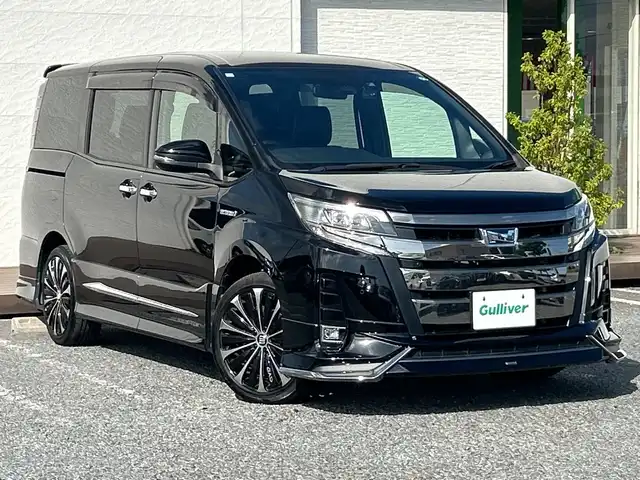 トヨタ ノア ハイブリッド Si ダブルバイビーⅡ 千葉県 2019(令1)年 6.1万km ブラック モデリスタエアロ 18インチAW  9型ナビNSZT-Y68T バックカメラ 両側パワースライドドア シートヒーター クルコン ETC USB 革調シートカバー LEDライト オートライト ソナー