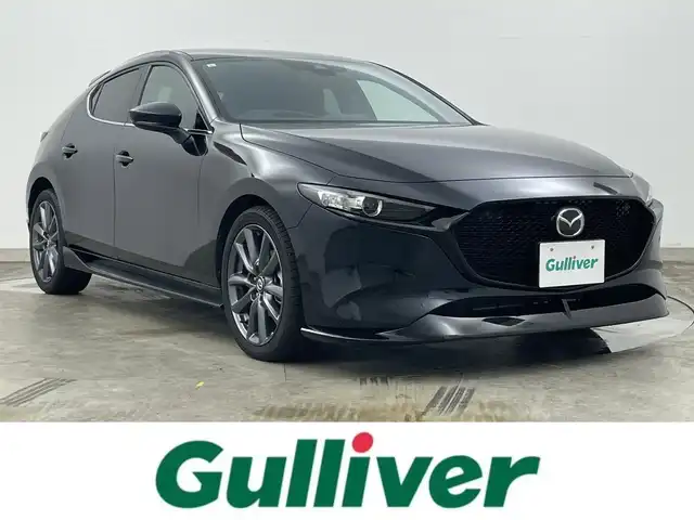 マツダ マツダ３ファストバック 15S ツーリング 岡山県 2021(令3)年 1.2万km ジェットブラックマイカ 純正エアロ（F/S/R）/8.8インチマツダコネクトナビ/地デジ/BT/CD/DVD/USB/HDMI/360度セーフティパッケージ/スマートブレーキサポート/レーンキープアシスト/レーダークルーズコントロール/ブラインドスポットモニター/ヘッドアップディスプレイ/ビルトインETC/純正前後ドラレコ /オートハイビーム /LEDヘッドライト/純正フロアマット /プッシュスタート /スマートキー