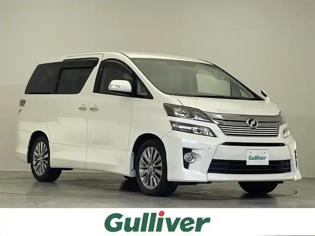 トヨタ ヴェルファイア 2．4Z ゴールデンアイズⅡ 滋賀県 2014(平26)年 5.7万km ホワイトパールクリスタルシャイン 社外8インチナビ/・Bluetooth/CD/DVD/USB/フルセグ/フリップダウンモニター/両側パワースライドドア/パワーバックドア/キセノンライト/ハーフレザーシート/オットマン/ステアリングリモコン/スマートキー/AC１００V電源