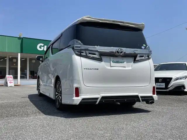 トヨタ ヴェルファイア Z Gエディション 千葉県 2019(令1)年 1.8万km ホワイトパールクリスタルシャイン エアロ/サンルーフ/黒レザーシート/純正10インチSDナビ/・CD/DVD/MSV/Bluetooth/フルセグ/純正12.1インチフリップダウンモニター【V12T-R68C】/両後パワースライドドア/パワーバックドア/前席パワーシート/前席シートヒーター/前席シートベンチレーション/デジタルインナーミラー/トヨタセーフティーセンス/・プリクラッシュセーフティー/・レーンディパーチャーアラート/・パーキングサポートブレーキ/・ロードサインアシスト/・ブラインドスポットモニター/アダプティブクルーズコントロール/ステアリングヒーター/スマートキー/前後コーナーセンサー/AC100V100W電源/純正ドライブレコーダー【DRT-H68A】/ビルトインETC/純正18インチアルミホイール/ウッドコンビステアリング/純正LEDヘッドライト/フォグランプ/サイド＆カーテンエアバッグ/ドアバイザー/新車時保証書＆取扱説明書