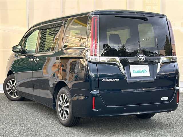 トヨタ エスクァイア Gi 福岡県 2020(令2)年 2.5万km ブラッキッシュアゲハガラスフレーク フリップダウンモニター/純正9インチナビ/（BT/フルセグ/AM/FM/DISC/SD/SDREC)/バックカメラ/両側パワースライドドア/クルーズコントロール/DUALオートACC/LEDヘッドライト/フォグランプ/オートマチックハイビーム/オートライト/レザーシート/DN席シートヒーター/純正15インチAW/アイドリングストップ/横滑り防止装置/盗難防止装置/レーンキープアシスト/コーナーセンサー/USB入力端子/オート電動格納ミラー/後席用テーブル/サンシェード/スマートキー/ETC/保証書/取扱説明書