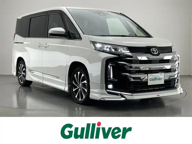 トヨタ ノア ハイブリッド S－Z 愛知県 2023(令5)年 1.2万km ホワイトパールクリスタルシャイン 純正１０．５型ナビ　モデリスタ　快適利便Ｈｉｇｈ　禁煙　バックカメラ　ＤＶＤ　前後ドラレコ　ＡＣ１００Ｖ　ＥＴＣ２．０　シートヒーター　衝突軽減　追従クルコン　ＢＳＭ　ＬＥＤライト　アドバンスドドライブ　モデリスタシグネチャーイルミ　パワーバックドア　オットマン　ハーフレザー　USBポート
