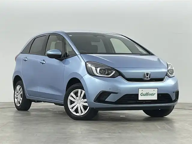 ホンダ フィット e:HEVホーム 福島県 2021(令3)年 5.9万km ライトブルー ホンダセンシング/・衝突軽減ブレーキ/・誤発進抑制機能/・後方誤発進抑制機能/・近距離衝突軽減ブレーキ/・路外逸脱抑制機能/・渋滞追従機能付アダプティブ・クルーズ・コントロール/・車線維持支援システム/・先行車発進お知らせ機能/・標識認識機能/コンフォートビューパッケージ/・親水/ヒーテッドドアミラー/・熱線入りフロントウインドウ/・PTCヒーター /純正ナビゲーション/・型式：VXM-205VFEi/・【TV/Bluetooth/CD/DVD/AM・FM/・バックカメラ/・ETC/前後ドライブレコーダー/プッシュスタート/・スマートキー/・電子パーキング/・オートホールド/革巻きステアリング/・ステアリングスイッチ/LEDヘッドライト/・オートライト/・オートハイビーム/・ヘッドライトリベライザー/純正フロアマット/電動格納ウィンカーミラー/ドアバイザー