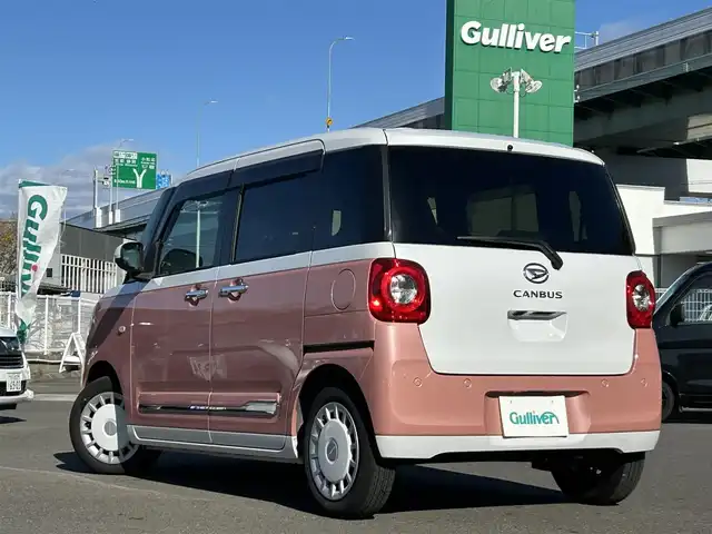 ダイハツ ムーヴ キャンバス ストライプス G 愛知県 2023(令5)年 2.1万km シャイニングホワイトパール/アプリコットピンクメタリック スマートアシスト/　・プリクラッシュセーフティ/　・車線逸脱警報システム/　・先行者発進お知らせ機能/両側パワースライドドア/シートヒーター（全席）/電動パーキングブレーキ/ドライブレコーダー（前後）/ホットカップホルダー（前席）/社外ディスプレイオーディオ/　・Bluetooth/　・CD/DVD/　・AM/FM/　・USB/　・iPod/　・AUX/　・AndroidAuto/社外フロアマット/コーナーセンサー（前後）/LEDヘッドライト/オートライト/カーテンエアバック/ETC/スマートキー/スペアキー×１/取扱説明書/保証書