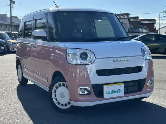 ダイハツ ムーヴ キャンバス ストライプス G 愛知県 2023(令5)年 2.1万km シャイニングホワイトパール/アプリコットピンクメタリック スマートアシスト/　・プリクラッシュセーフティ/　・車線逸脱警報システム/　・先行者発進お知らせ機能/両側パワースライドドア/シートヒーター（全席）/電動パーキングブレーキ/ドライブレコーダー（前後）/ホットカップホルダー（前席）/社外ディスプレイオーディオ/　・Bluetooth/　・CD/DVD/　・AM/FM/　・USB/　・iPod/　・AUX/　・AndroidAuto/社外フロアマット/コーナーセンサー（前後）/LEDヘッドライト/オートライト/カーテンエアバック/ETC/スマートキー/スペアキー×１/取扱説明書/保証書