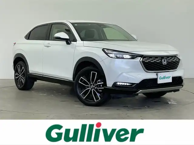 ホンダ ヴェゼル ハイブリッド e:HEV Z 富山県 2023(令5)年 1.6万km プラチナホワイトパール 純正9型ホンダコネクトディスプレイ/（AM/FM/USB/BT/AppleCarPlay/AndroidAuto）/フルセグTV/バックカメラ/寒冷地仕様/衝突被害軽減ブレーキ/アダプティブクルーズコントロール/レーンキープアシスト/ブラインドスポットモニター/オートマチックハイビーム/パーキングセンサー/電動リアゲート/ハーフレザーシート/前席シートヒーター/ステアリングヒーター/パドルシフト/置くだけ充電/ビルトインETC2.0/スマートキー×２/プッシュスタート/純正１８インチAW/純正フロアマット/保証書