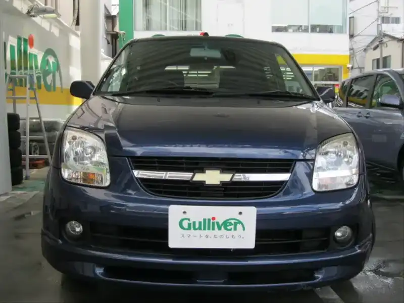 カタログ画像：シボレークルーズ（CHEVROLET CRUSE） １．３ＬＴ Ｓ－セレクション 2004年12月 LA-HR52S 1300cc パールメタリックカシミールブルー 燃費17.0km / l  フロント