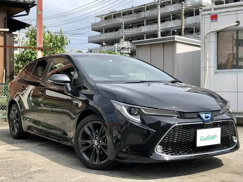 カタログ画像：カローラツーリング（COROLLA TOURING） ハイブリッド ダブルバイビー 2019年10月 6AA-ZWE214W 1800cc ブラックマイカ 燃費24.4km / l メイン